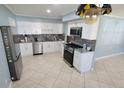 Bright kitchen featuring white cabinets, stainless steel appliances, and granite countertops at 904 W Braddock St, Tampa, FL 33603