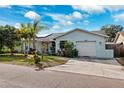 Well-maintained single-story home with mature trees, a charming yard, and an attached garage at 1035 County Road 90, Palm Harbor, FL 34684