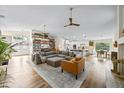 Open-concept living room featuring a large sectional, hardwood floors, and a built-in bookcase at 10562 99Th St, Largo, FL 33773