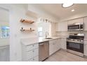 Bright, remodeled kitchen features white cabinets, quartz countertops, and stainless steel appliances at 10829 65Th N Way, Pinellas Park, FL 33782