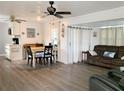 Open-concept living and dining area with hardwood floors, fan, and cozy furniture at 114 W Saint Johns Way, Apollo Beach, FL 33572