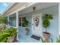 Close-up of the front door with plants, featuring a decorated glass door and a well-manicured entrance at 1211 Carolyn Ln, Clearwater, FL 33755