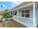 Inviting front porch with white railing, showcasing a glimpse of the charming exterior of the house at 1211 Carolyn Ln, Clearwater, FL 33755