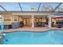 Inviting screened-in outdoor patio area with a large in-ground pool and comfortable seating at 12478 93Rd Way, Largo, FL 33773