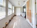 Bright living room features tiled floors and windows with great natural light at 13331 1St E St, Madeira Beach, FL 33708