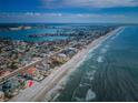 Breathtaking aerial view of the beachfront property with a pool, overlooking the ocean and coastline on a clear day at 15912 Gulf Blvd, Redington Beach, FL 33708