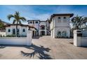 Elegant two-story home featuring a grand entrance, manicured landscaping, and a spacious driveway at 15912 Gulf Blvd, Redington Beach, FL 33708