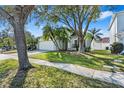 Charming single-Gathering home with a well-manicured lawn, mature trees, and a two-car garage at 1645 Fennsbury Ct, Wesley Chapel, FL 33544