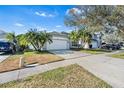 Charming single-Gathering home with a well-manicured lawn, mature trees, and a two-car garage at 1645 Fennsbury Ct, Wesley Chapel, FL 33544