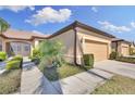 Beautiful single-story home featuring a tile roof, attached garage, and lush landscaping at 237 Shell Falls Dr, Apollo Beach, FL 33572