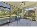 Relaxing screened patio with ceiling fan, neutral rug and views of the backyard at 237 Shell Falls Dr, Apollo Beach, FL 33572