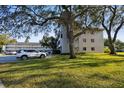 Exterior of building showcasing stairs, parking, and shade trees at 2441 Persian Dr # 53, Clearwater, FL 33763