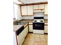 Functional kitchen featuring a double sink, tile floors and black appliances at 2567 Bentley Dr, Palm Harbor, FL 34684