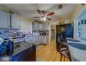 A cozy kitchen featuring stainless steel appliances, wood-look floors, a ceiling fan, and a breakfast bar at 2749 16Th N Ave, St Petersburg, FL 33713