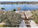 Aerial view of a home near the water, showcasing its proximity to a lake in a residential community at 2811 Butterfly Landing Dr, Land O Lakes, FL 34638