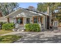 Quaint home boasting a tidy yard, distinguished by its white exterior and decorative landscaping accents at 321 W Wilder Ave, Tampa, FL 33603