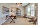 Well-lit home office features a ceiling fan, large window, modern furniture, decorative shelving and a wood desk at 4006 112Th E St, Palmetto, FL 34221