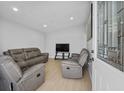 Cozy living room featuring plush seating, neutral walls, and natural light filtering through the windows at 4414 W Paris St, Tampa, FL 33614