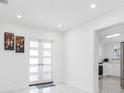 Bright foyer featuring sleek tile floors, modern lighting and neutral walls at 4716 Eldorado Dr, Tampa, FL 33615