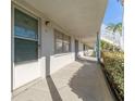 Exterior building walkway with trimmed bushes, stairs, and access to resident units at 5246 81St N St # 6, St Petersburg, FL 33709