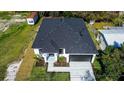 A stunning overhead view of a single-story home with a black roof, a large yard and minimalistic landscaping at 5885 114Th N Ter, Pinellas Park, FL 33782