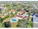 Aerial view of a beautiful property showcasing multiple buildings, lush landscaping, and a large clover-shaped pool at 6010 17Th S Ave, Gulfport, FL 33707