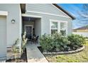 Inviting front porch with seating area and landscaping at 725 Garden Oaks Sq, Seffner, FL 33584