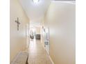 Open hallway showcasing tile floors, neutral paint, and seamless transition to the living room at 780 Spring Flowers Trl, Brandon, FL 33511