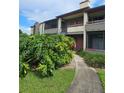 Condo building features lush landscaping and convenient stair access at 10263 Gandy Blvd # 2314, St Petersburg, FL 33702