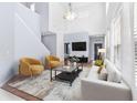 Bright living room with high ceilings, modern furniture, and hardwood floors creates an inviting space at 20033 Heritage Point Dr, Tampa, FL 33647