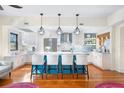 Well-lit kitchen with stainless steel appliances, a center island with seating, and vibrant backsplash at 210 22Nd Ne Ave # 14, St Petersburg, FL 33704