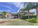 Beautiful house exterior with lush landscaping and palm trees at 26848 Shoregrass Dr, Wesley Chapel, FL 33544