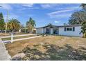 Newly renovated home with a white brick exterior and gray accents at 2904 Matchlock Dr, Holiday, FL 34690