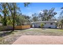 Spacious fenced backyard with a brick patio, solar panels, and a well-manicured lawn at 3087 Duane Ave, Oldsmar, FL 34677