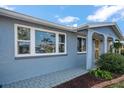 Close-up of the home's exterior, featuring a stylish front entrance and well-kept landscaping at 3832 Star Island Dr, Holiday, FL 34691