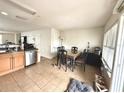 Dining area adjacent to kitchen with glass-top table and chairs at 4883 Tuscan Loon Dr, Tampa, FL 33619