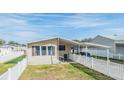 Front view of manufactured home with white picket fence at 5330 Dean Dairy Rd, Zephyrhills, FL 33541