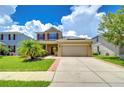 Two-story house with solar panels and a two-car garage at 5365 Shasta Daisy Pl, Land O Lakes, FL 34639