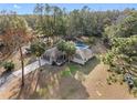 Expansive aerial view of a home with a private pool, mature trees, and lush landscaping on a large lot at 9445 Preston Rd, Brooksville, FL 34601