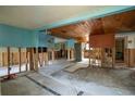 Under renovation, gutted interior showing exposed framing and flooring at 9810 Parsons St, Tampa, FL 33615