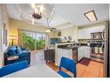 Cozy living room featuring a sliding door to the balcony, a TV, and comfortable furniture at 13235 Gulf Blvd # 306, Madeira Beach, FL 33708