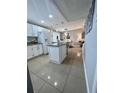 Bright and airy kitchen with stainless steel appliances and an island with bar seating at 2013 Darlington Dr, Tampa, FL 33619