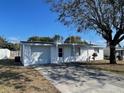 Inviting single-story home with a spacious driveway and well-kept landscaping at 2036 Melody Dr, Holiday, FL 34691
