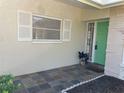 Well-lit front entrance featuring a bright green door and tiled entryway at 2051 High Ridge Dr, Clearwater, FL 33763