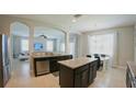 Open-concept kitchen with island, stainless steel dishwasher and granite countertops at 3328 W Palmetto St, Tampa, FL 33607