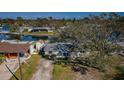 Aerial view of a cozy home near the water featuring a well-manicured lawn and nearby shed at 4601 Carson Ne St, St Petersburg, FL 33703