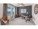 Home office with a large window, comfortable chair, and a wooden desk at 4978 Eagle Rock Dr, Wimauma, FL 33598