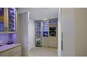 The butler pantry is equipped with a wine fridge and custom glassware shelving at 5120 Marina Way # 6603, Tampa, FL 33611