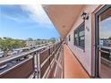 Condo exterior featuring a long balcony with metal railing and exterior light at 5980 80Th N St # 410, St Petersburg, FL 33709