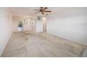 Bright living room with neutral walls, a ceiling fan, and carpet at 5980 80Th N St # 410, St Petersburg, FL 33709